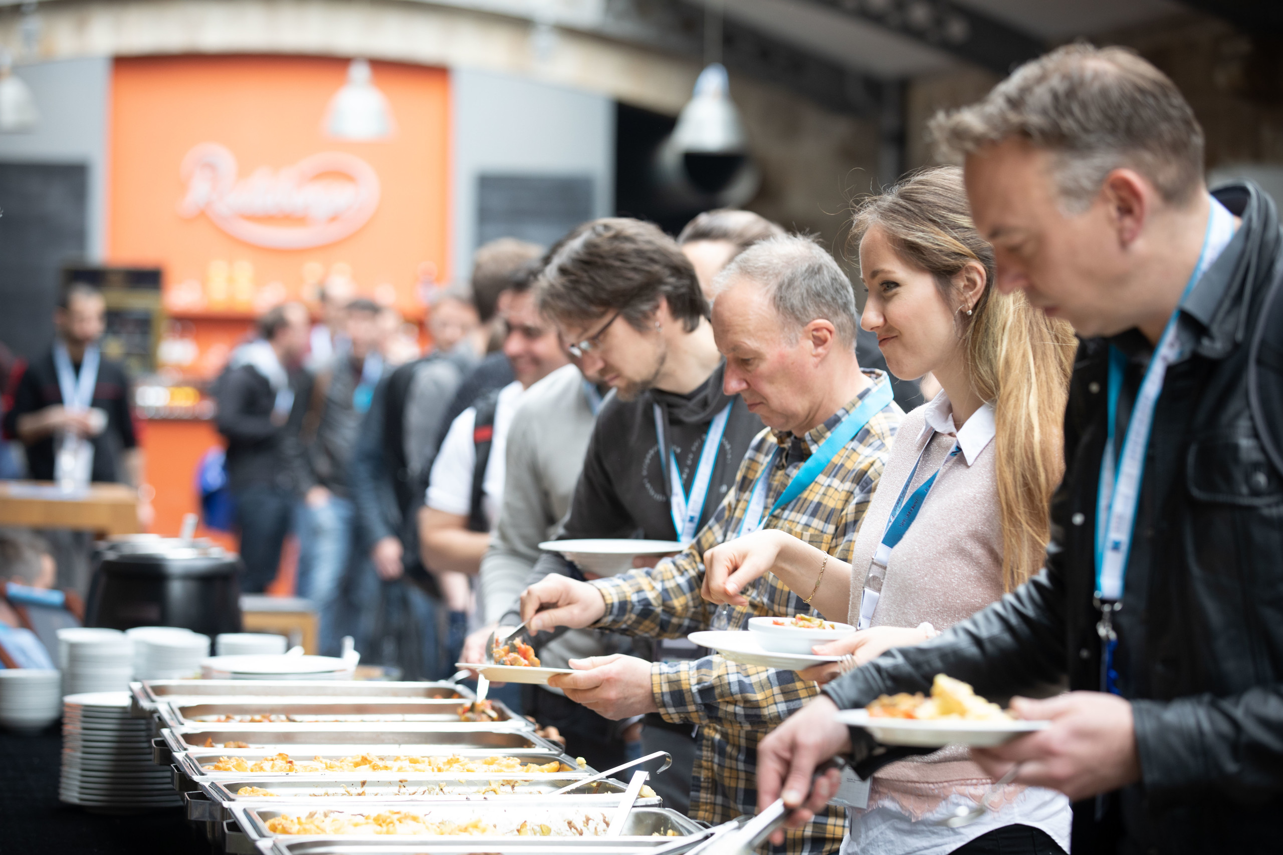 Attendees queuing for food during lunch break